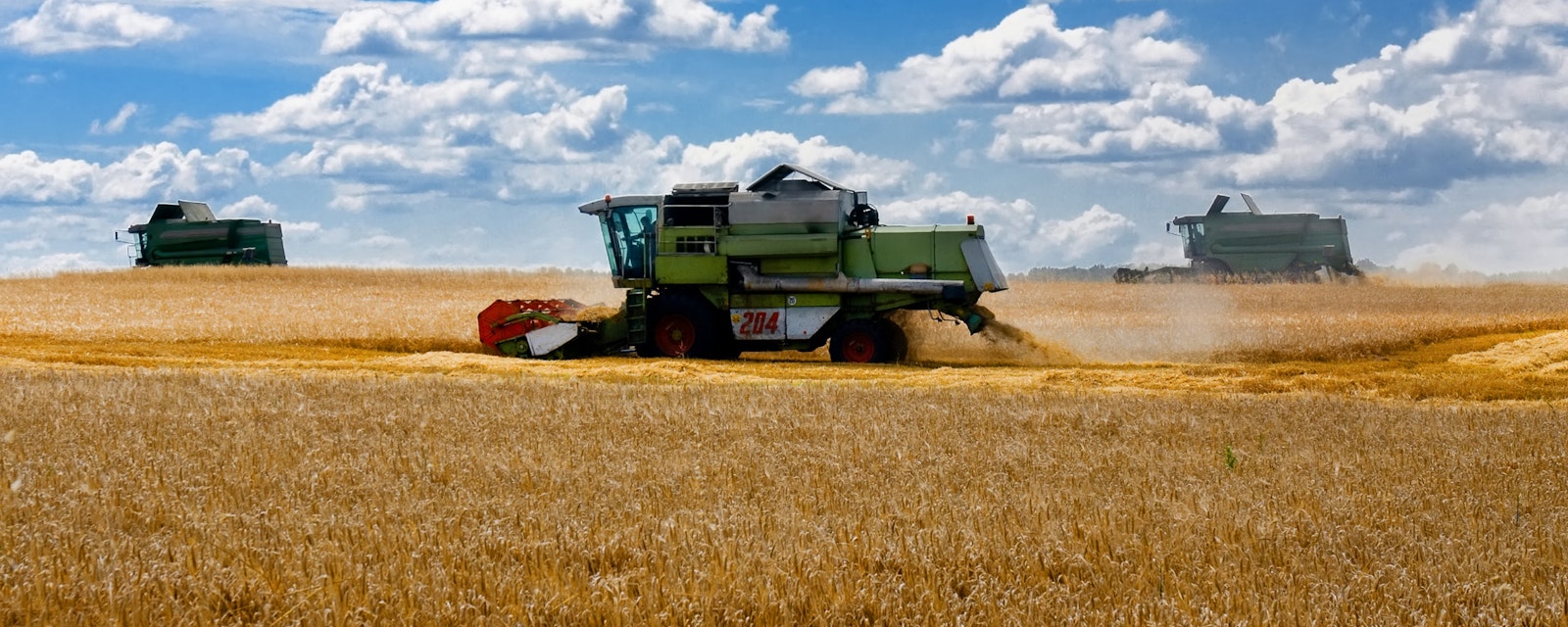 Harvesters,Work,In,The,Wheat,Harvesting,Field,In,Ukraine